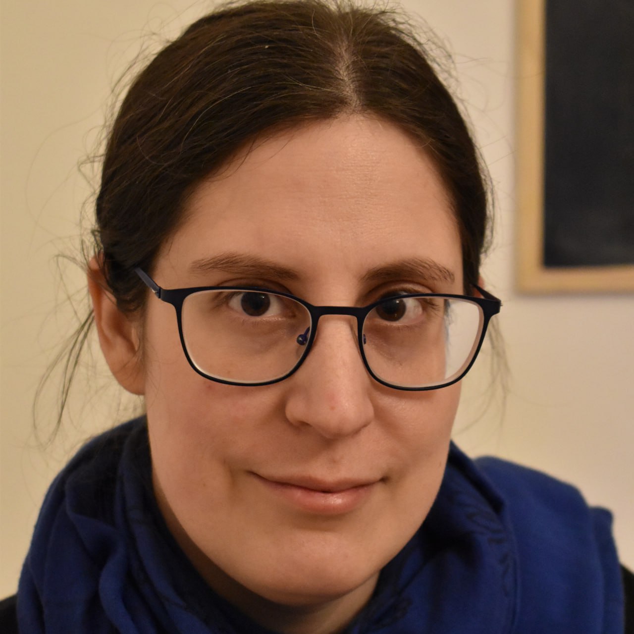 Zsuzsanna Pongrácz, wearing glasses, looking at the camera